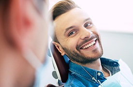 Man smiling while talking to dentist at appointment