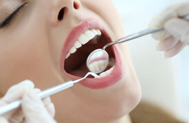 Dentist looking in woman’s mouth