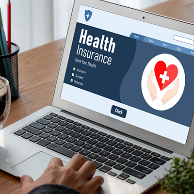 Looking at health insurance page on laptop