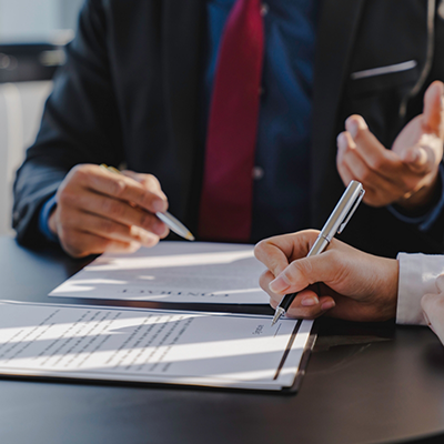 Filling out form while man in suit talks