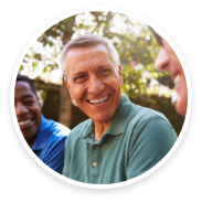 Man in green shirt outside smiling
