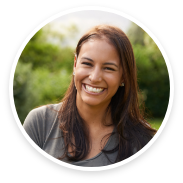 Woman with long hair and grey shirt smiling
