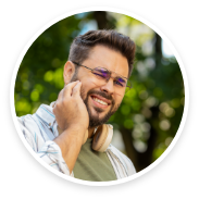 Man with glasses rubbing his jaw