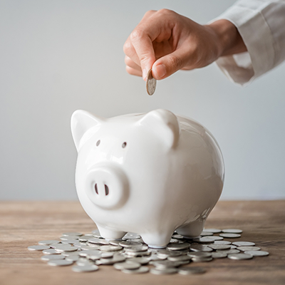 Placing coin in a piggy bank